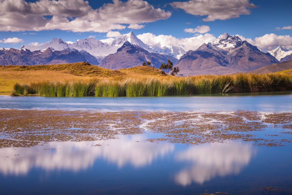 Turquoise laguna Wilcacocha with mirrored reflection of the Cordillera Blanca Mountain Range