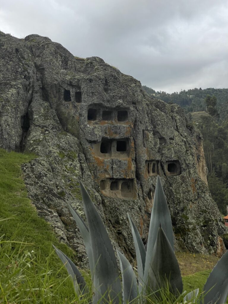 A photo of the Ventanillas de Otuzco. The structure is made up of little windows carved into volcanic rock.