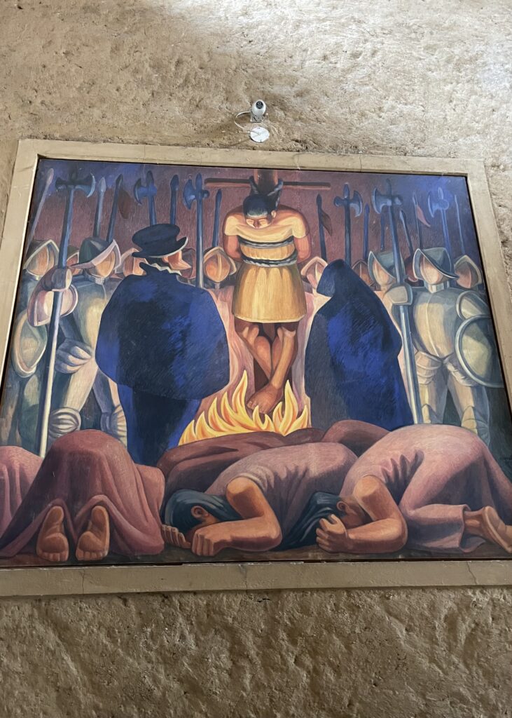 A painting of the Inca Emperor being burnt at the stake surrounded by the Spanish army. 
