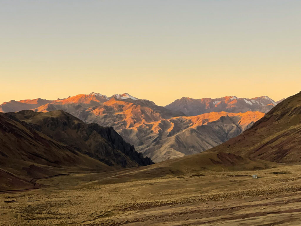 Snow-capped mountains at golden hour on the way down from Pallay Punchu to Occobamba