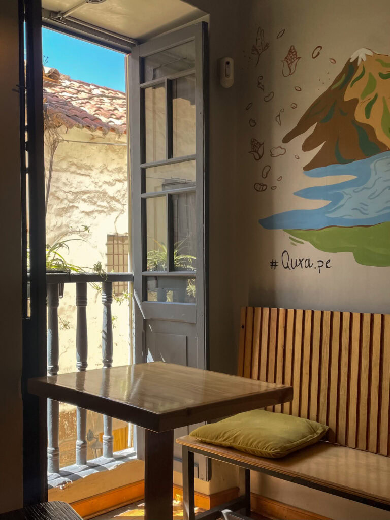 A table by the window at Qura Restaurant In Cusco
