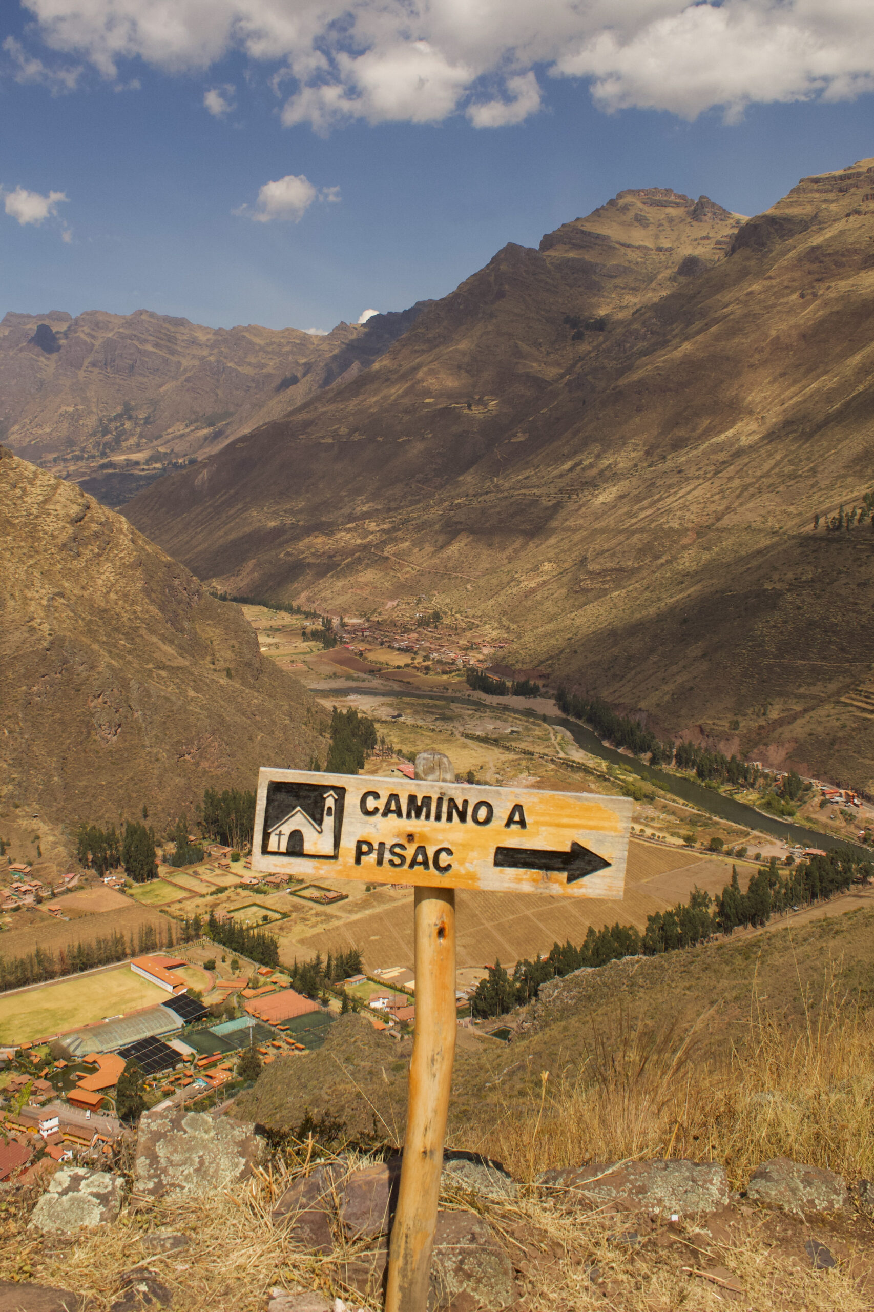 The 'Camino a Pisac' sign pointing in the direction of Pisac town from the ruins.